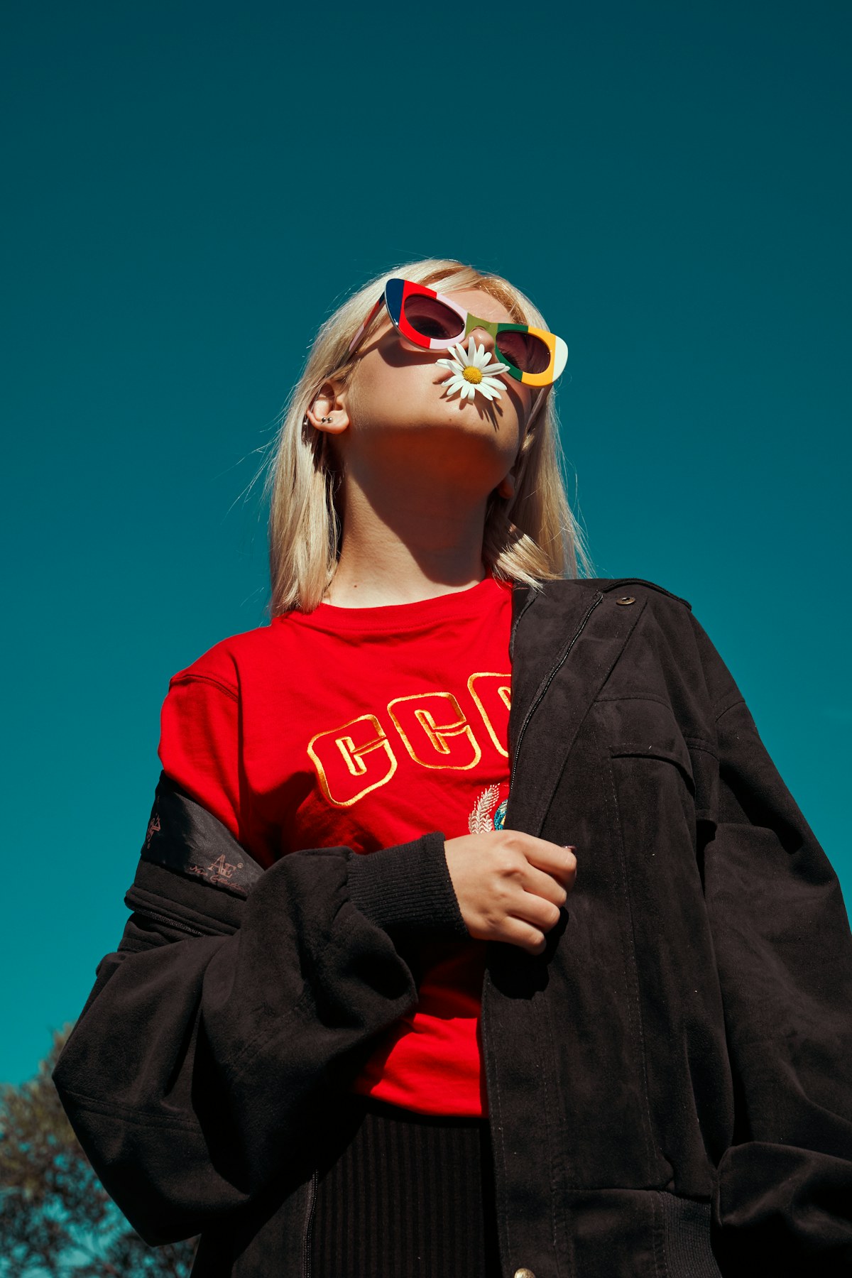 Colorful editorial portrait with translucent sunglasses